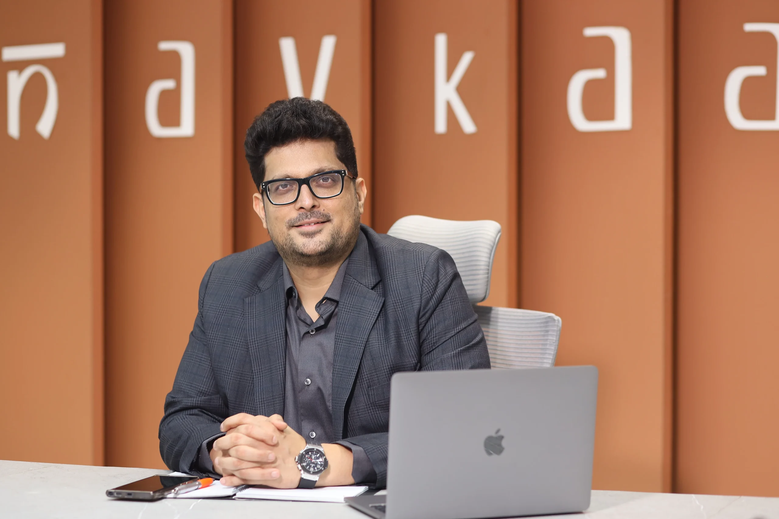 Vinit Jain, Managing Director of Navkaar Group, seated at his desk